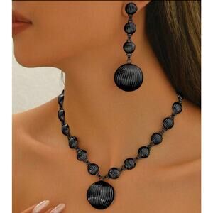 Trendy pierced black indented circle necklace and earring set